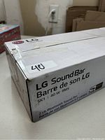Box of LG SK1 Bluetooth Sound Bar highlighting brand and model information, showing 40W RMS and 2 channel Bluetooth feature.