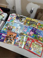 Top view photo showing assortment of kids books including Peppa Pig, Franklin, Magic School Bus, and other titles spread out on a table.