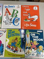 Photo of four children's books: Dr. Seuss's ABC, Green Eggs and Ham by Dr. Seuss, The Bear Detectives, and The Berenstain Bears On the Moon.