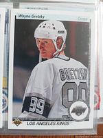 Close-up photo of Wayne Gretzky hockey card from the Upper Deck High & Low 1990-1991 Series showing the player in white Los Angeles Kings uniform with jersey number 99.