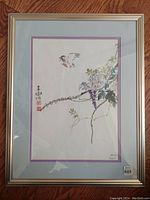 Full view of Robert Meyer "Mid Flight" print in metal frame with double mats under glass showing bird and floral elements