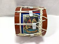 Top view of miniature Lambeg drum showing printed panel with King William III on horse and text 'For God and Ulster' and 'The Glorious Memory 1690'.