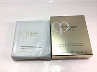 Front view of sealed white packet and gold box of Cle De Peau Beaute Eye and Lip Makeup Remover Towelettes showing branding and product name.