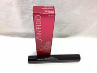 Two tubes of Shiseido Perfect Mascara in black tubes in front of their original red boxes.