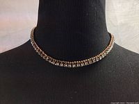 Swarovski choker necklace displayed on black mannequin neck showing clear faceted crystals in gold-tone setting