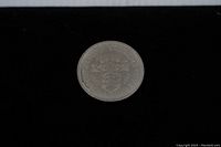 Reverse side of the Canadian silver dollar coin featuring the Canadian coat of arms.