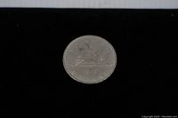 Reverse side of 1978 Canadian silver dollar featuring a stylized canoe with paddlers.