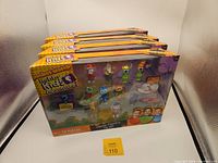 Four boxed Deluxe Mystery Fig Sets from Pocket Watch Hobby Kids Adventures, unopened and new in box, each with 13 colorful figures visible through the window display.
