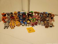 Full view of 30 Madame Alexander dolls displayed in rows showing mix of costumes and outfits