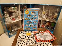 Full view of open sectioned box with sealed bags containing multiple figures and sets inside along with certificate and instruction posters.