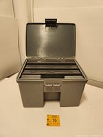 Large gray Plano 1232 Stowaway tackle storage case open, showing internal structure for smaller cases.