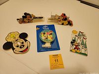 All 5 items arranged on table: Mickey and Minnie combs, 2 light switch covers (Mickey and castle design), and Disney-packaged night light