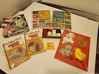 Lot overview showing all items together: vintage puzzles, stamps, and poker chips displayed on a table.