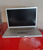 Full open MacBook Pro laptop showing screen and keyboard in silver aluminum body.