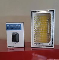 Carson MicroBrite Plus pocket microscope box and one set of 12 prepared microscope slides sealed in plastic case.