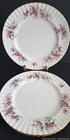 Top view of two Royal Albert Lavendar Rose bone china salad plates showing floral pattern and gold rim.