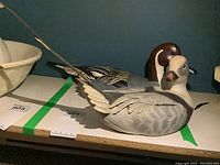 Pair of wooden duck decoys displayed on a flat surface, showing overall size and shape.