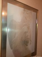 Full view of framed foil print under glass in gold-tone metal frame