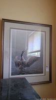 Full view of framed print hanging on wall showing artwork, mat, frame