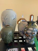 Front view of four vases showing varied designs and colors.