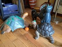 Group view of all wood animal figures placed on wooden floor, showing each figure's size and state.