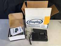 Freeplay self powered radio in its original box with packaging and accessories visible
