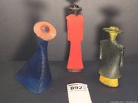 Three Catwalk figurines (blue, red, green) displayed side by side