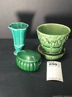 Green McCoy plant pot with attached catch plate and two additional pottery pieces in green and turquoise shades