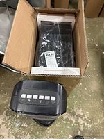 Top view of Comfort Zone ceramic tower heater's control panel and boxed Matrexx 30 computer case.