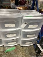 Two Sterlite plastic storage bins side by side on caster wheels, each with three drawers, white translucent plastic.