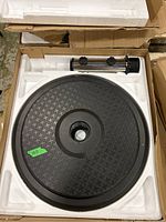 Umbrella base with cast iron textured round base and chrome adjustable pole in packaging.