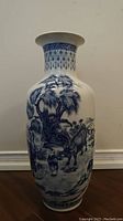 Front view of vase showing hand-painted pastoral scene with water buffalo and rider beneath tree