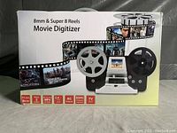 Front image of the retail box of the movie digitizer showing product features and image.