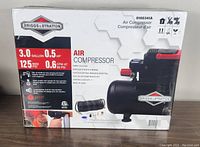 Front of the Briggs & Stratton air compressor box showing model number, specifications, and included accessories.