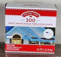 Front of box showing brand Holiday Time, 300 frost white and blue twin-cicle lights, white wire, lighted length 12 ft, indoor/outdoor and total length 13 ft (3.9 m).