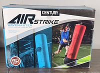 Box showing the Century Air Strike Wavemaster branding with images of two colors of training bags and weight specification of 90 lbs