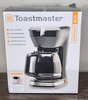 Photo of the Toastmaster 12 cup coffee maker box showing features like large capacity, removable brew basket, pause and serve function, keep-warm plate.