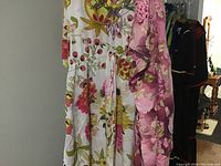 Two floral cover-up dresses: white maxi and pink kaftan