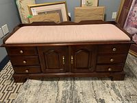 Front view showing drawers, cabinet doors, and upholstered seat