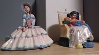 Both figurines with Royal Doulton box in background