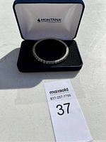 Silver tone stretch bracelet with raised dome-shaped design in branded Montana Silversmiths jewelry box