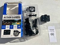 Proscan HD waterproof action camera box, camera, waterproof housing, and some accessories displayed on a white surface.