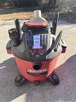 Front view of the large Craftsman wet/dry vacuum showing brand label, motor specifications, and hose attachments.