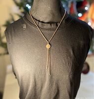 Front view of copper peace dove pendant necklace worn on a mannequin showing chain length and pendant detail.