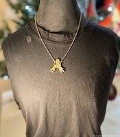 Full view of the necklace worn on a mannequin showing overall length and pendant position.