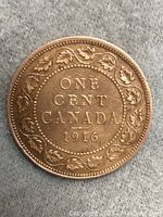 Reverse side of the coin showing 'ONE CENT CANADA 1916' surrounded by maple leaf wreath