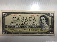 Front side of 1954 Canadian $20 bank note showing serial number, portrait of Queen Elizabeth II, and denomination text.
