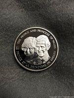 Obverse view of 1983 Canadian commemorative silver token showing engraved portraits of Prince Charles and Princess Diana with bilingual inscriptions.