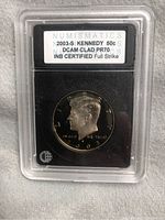 Obverse view of the 2003-S Kennedy Half Dollar coin in a certification holder showing the label with grade and details.