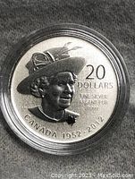 Obverse side showing Queen Elizabeth II with hat, denomination 20 dollars, and dates 1952-2012